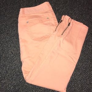 Orange skinny jeans with zipper ankles